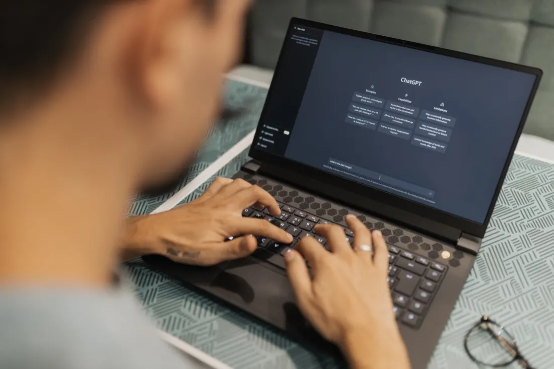 Specialist working with AI software on a laptop
