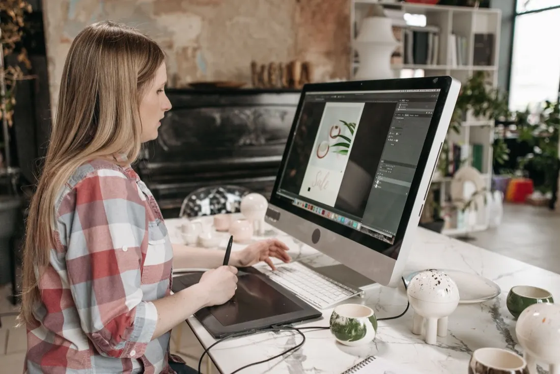 Designer working on website visuals with a drawing tablet