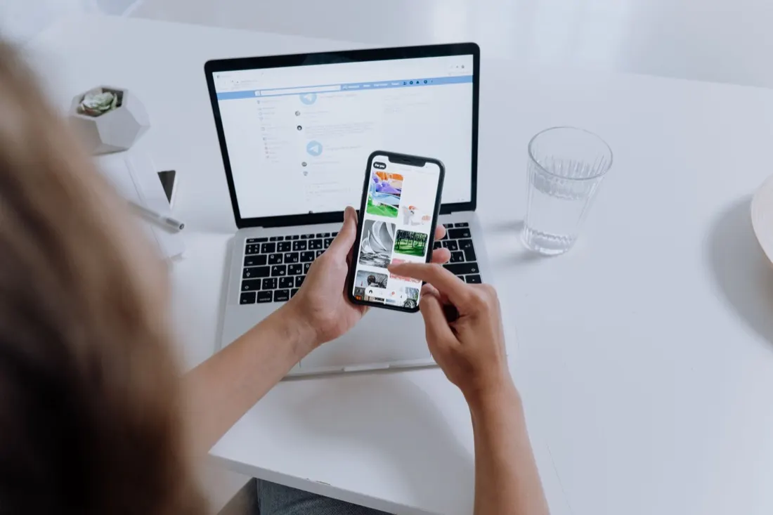 Mobile app developer testing iOS and Android apps on a smartphone