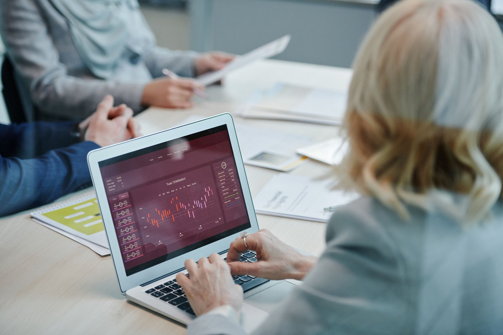 Team analyzing marketing data on a laptop in a meeting
